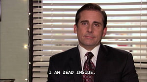 Michael Scott from The Office in a dark suit with a deadpan expression in an office setting HD wallpaper