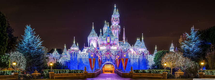 Disneyland Sleeping Beauty Castle Illuminated With Christmas Lights And Holiday Decorations At Night HD wallpaper