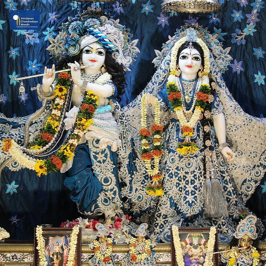 Radha Krishna Deities in Blue Attire with Floral Garlands and Silver Embroidery HD phone wallpaper