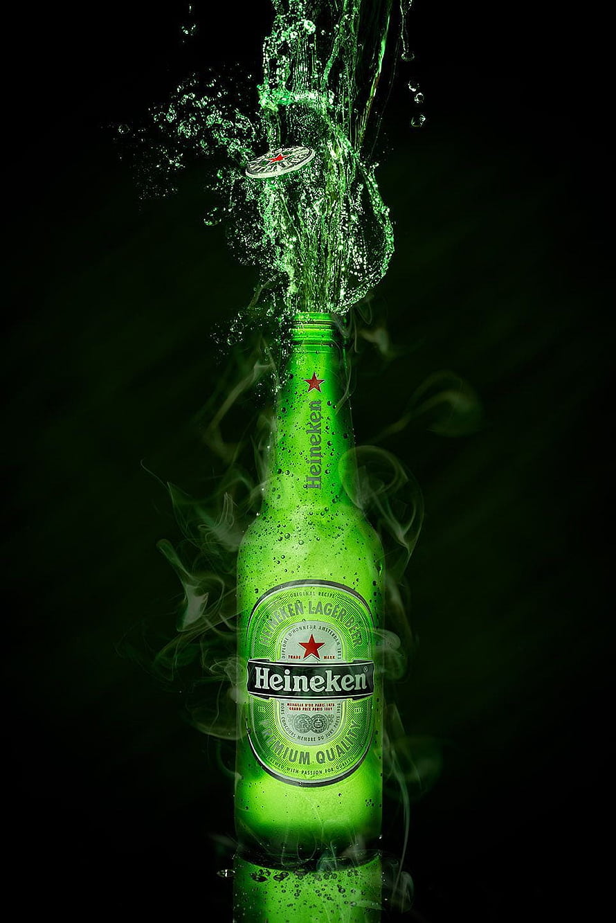 Heineken beer bottle with green liquid splash and smoke effect on black background HD phone wallpaper