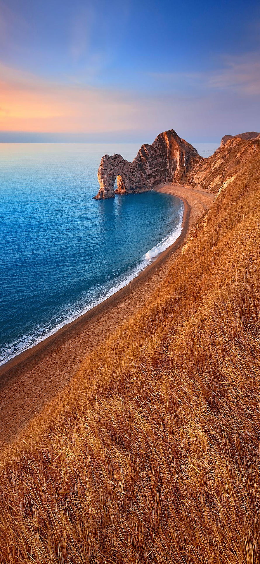Durdle Door Limestone Arch at Sunset, Dorset Coastline with Golden Grass and Blue Ocean HD phone wallpaper