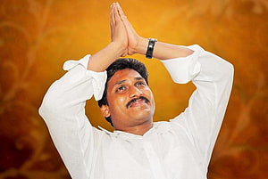 YS Jagan Mohan Reddy in White Shirt with Hands in Namaste Pose Against Golden Background HD wallpaper