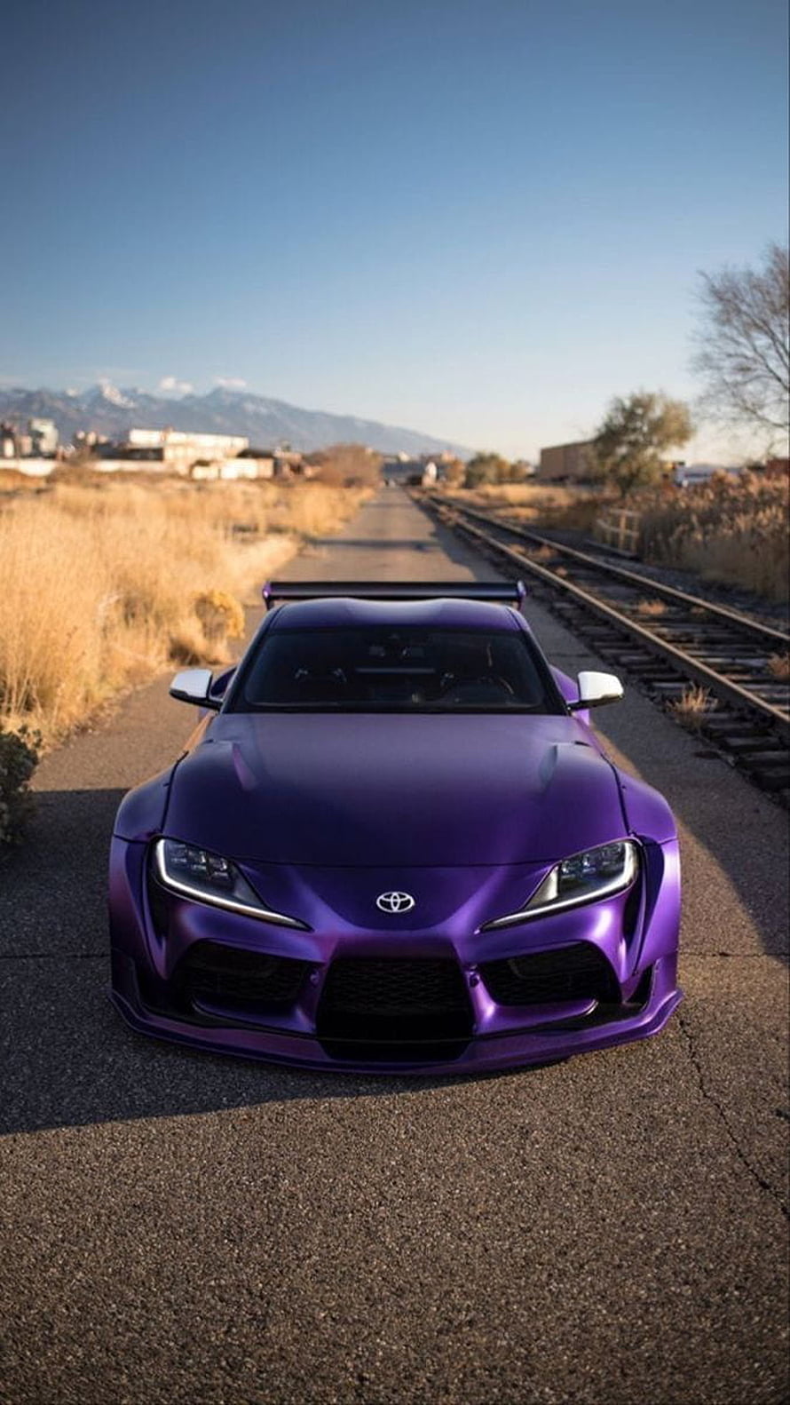 Matte Purple Toyota Supra A90 on Railroad Tracks with Mountain Background HD phone wallpaper