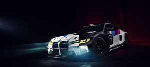 BMW M4 GT3 Race Car in Dark Studio Setting with Dramatic Lighting HD wallpaper