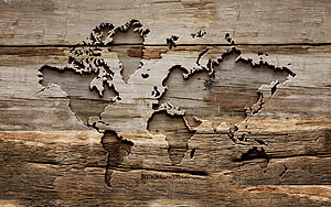 Carved World Map on Rustic Weathered Wood Planks HD wallpaper