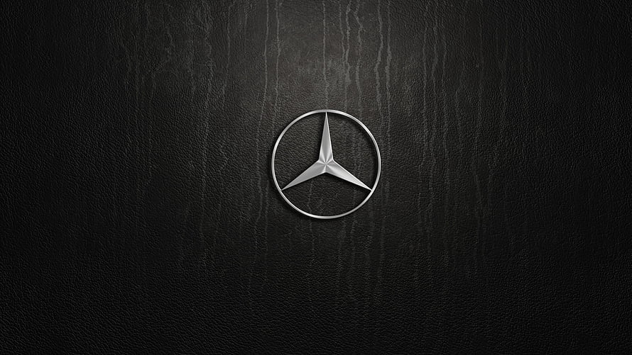 Mercedes-Benz Three-Pointed Star Emblem on Dark Textured Leather Surface HD wallpaper