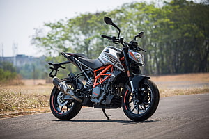 KTM 250 Duke street bike parked on an open road with orange trellis frame and black alloy wheels HD wallpaper