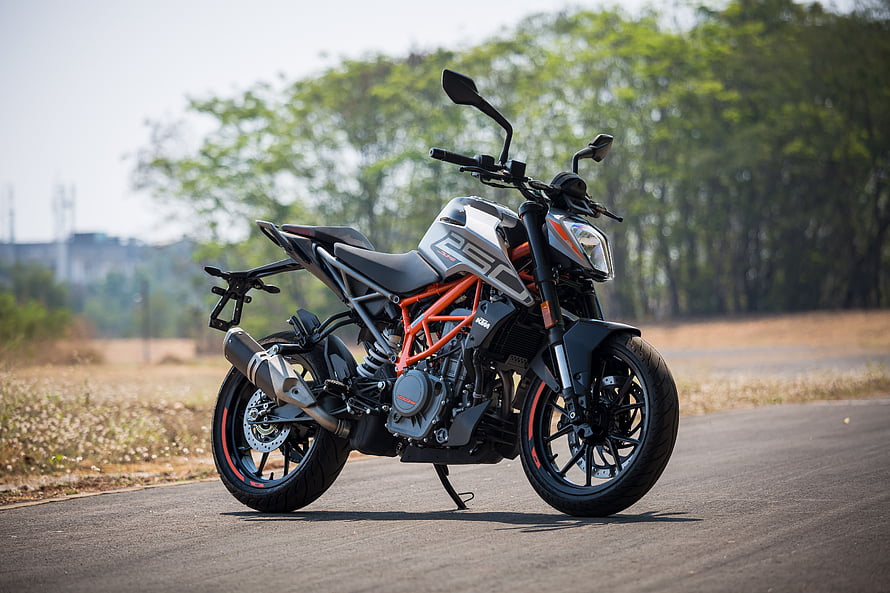 KTM 250 Duke street bike parked on an open road with orange trellis frame and black alloy wheels HD wallpaper