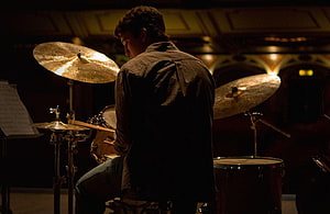 Whiplash Movie Scene: Drummer Silhouette in Dimly Lit Jazz Studio HD wallpaper