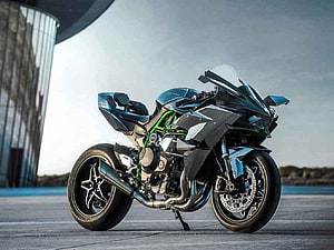 Kawasaki Ninja H2 Superbike with Green Frame Parked on Concrete HD wallpaper