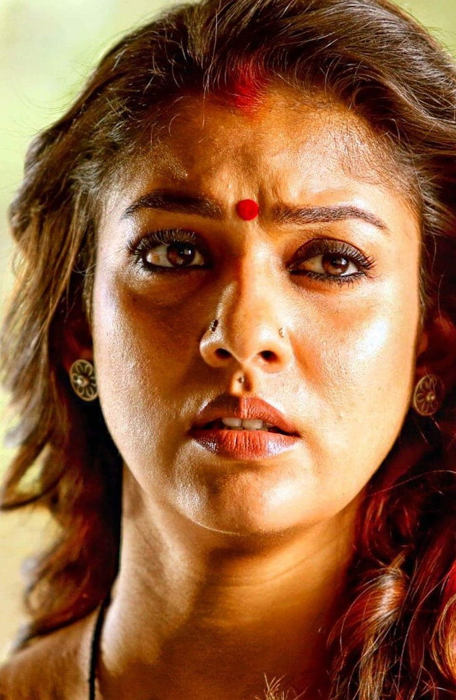 Close-up portrait of Indian actress Kajal Aggarwal with intense expression and traditional bindi HD phone wallpaper