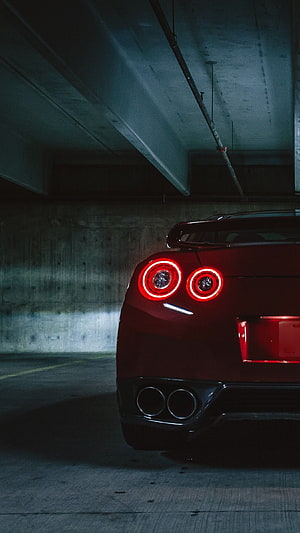 Rear View of Red Nissan GT-R with Circular Taillights in Parking Garage HD phone wallpaper