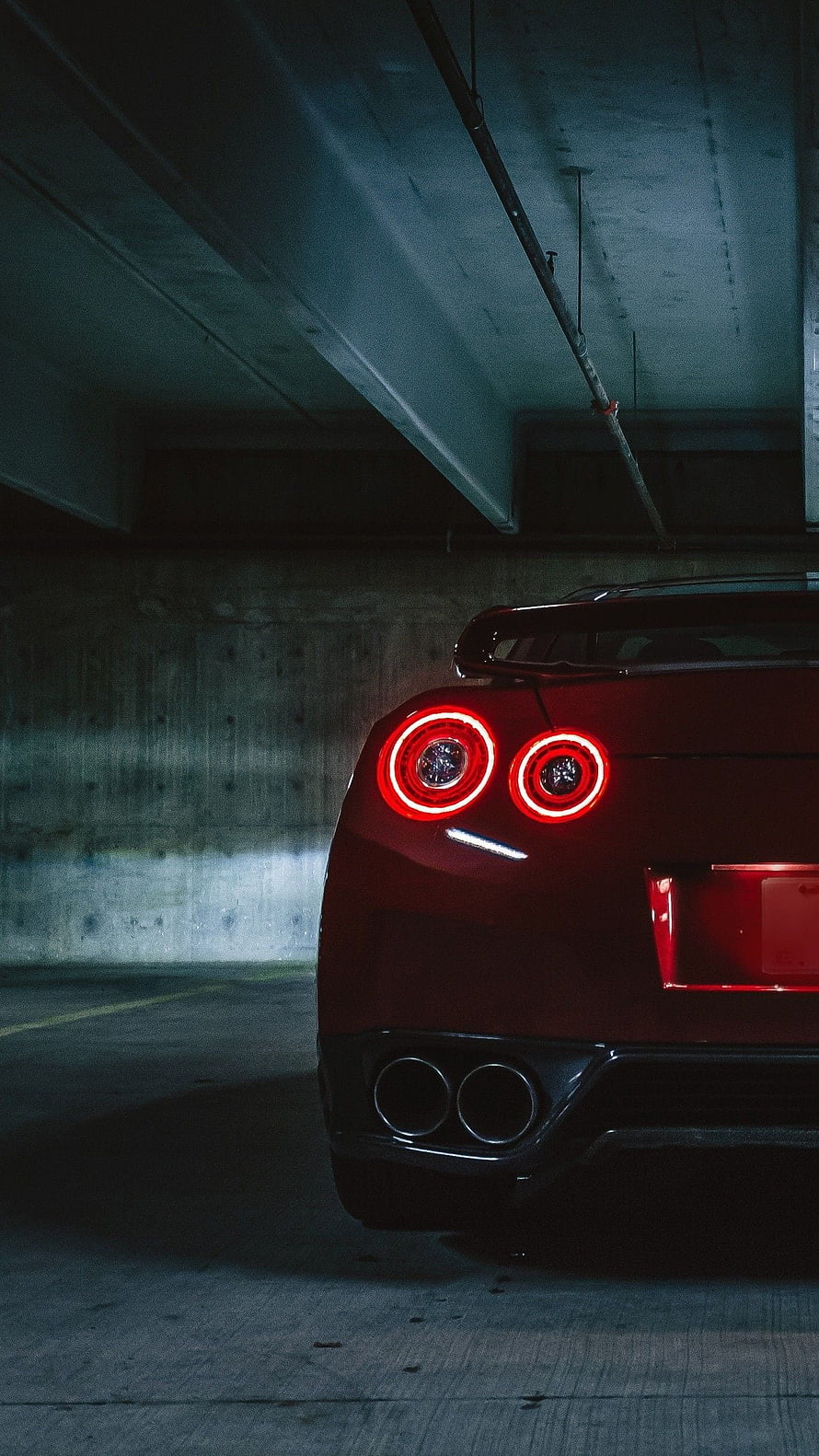 Rear View of Red Nissan GT-R with Circular Taillights in Parking Garage HD phone wallpaper