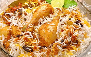 Traditional Chicken Biryani with Saffron Rice, Whole Chicken Legs, and Fresh Mint Garnish HD wallpaper