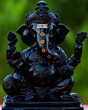 Black Obsidian Lord Ganesha Statue with Red Tilak and Ornate Crown HD phone wallpaper