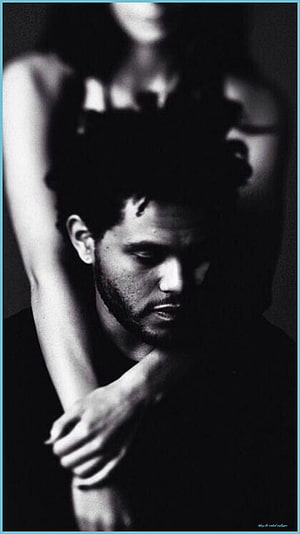 The Weeknd moody black and white portrait with dramatic shadows and intimate pose HD phone wallpaper