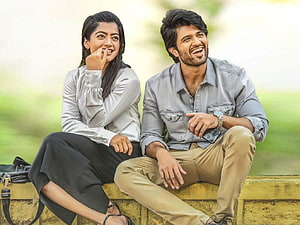Vijay Devarakonda and Rashmika Mandanna smiling together in a casual outdoor setting HD wallpaper
