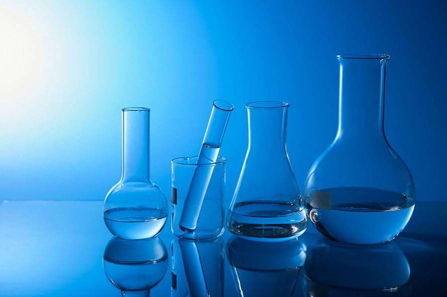 Blue Tinted Chemistry Laboratory Glassware with Beakers and Flasks on Reflective Surface HD wallpaper