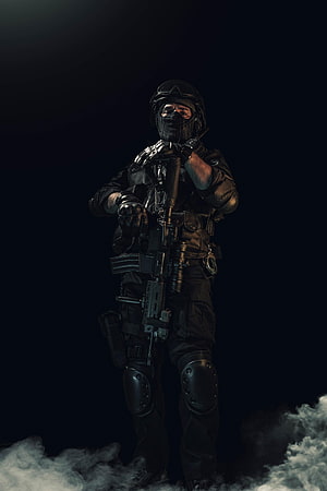 Tactical Soldier in Full Black Combat Gear Holding Rifle in Dark Smoke HD phone wallpaper