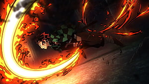 Tanjiro Kamado unleashing a fiery crescent slash in Demon Slayer anime action scene HD wallpaper