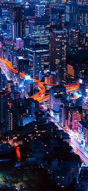 Vibrant Night Cityscape with Neon Lights and Long Exposure Traffic Trails HD phone wallpaper