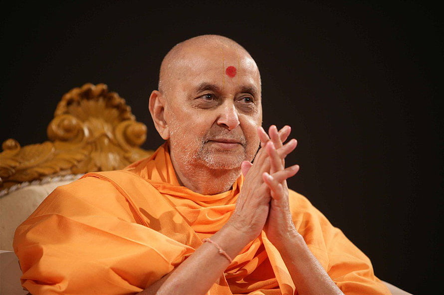 Pramukh Swami Maharaj in Orange Saffron Robes with Hands in Prayer HD wallpaper