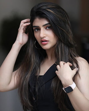 Portrait of a woman with long dark hair wearing a black dress and smartwatch, Sree Leela []: Latest , Stills of Sree Leela, sreeleela HD phone wallpaper