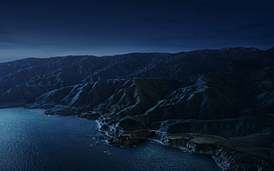 Moonlit Coastal Highway Winding Through Rugged Cliffs at Night HD wallpaper