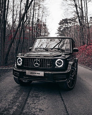 Black Mercedes-AMG G-Class SUV on a Forest Road HD phone wallpaper