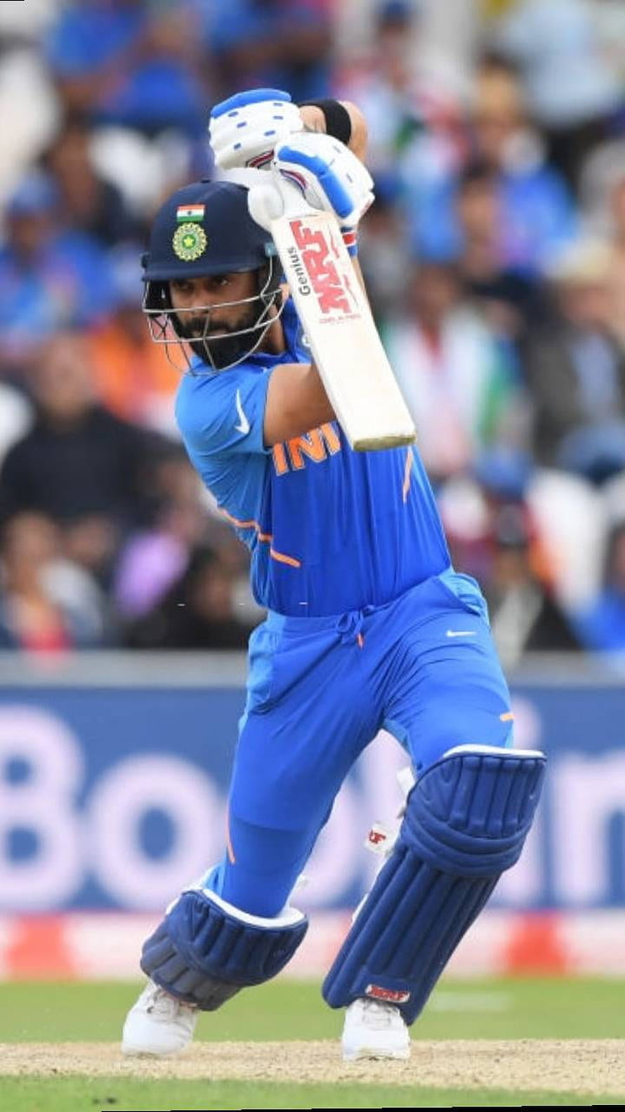 Virat Kohli in Action: Indian Cricket Team Batting Pose on the Field HD phone wallpaper