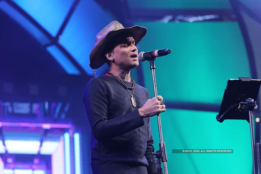 Zubeen Garg performing live on stage wearing a wide-brimmed hat and singing into a microphone HD wallpaper