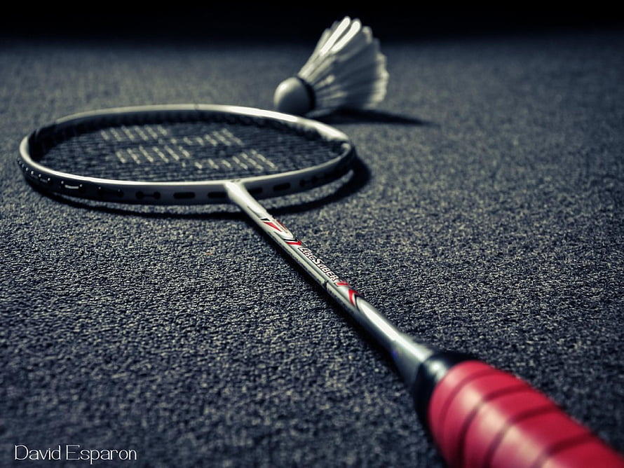 Badminton Racket and Shuttlecock on Court Surface HD wallpaper