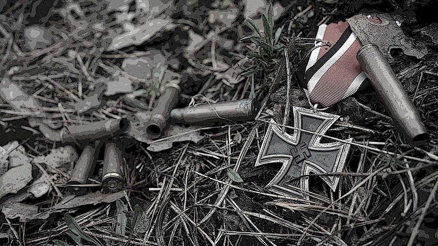 Abandoned Iron Cross Medal and Shell Casings in Overgrown Battlefield Debris HD wallpaper