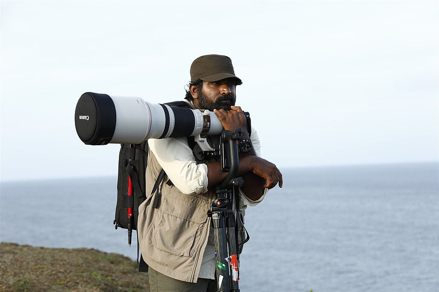 Vijay Sethupathi as a wildlife photographer with a large telephoto lens by the sea HD wallpaper