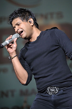 KK Live Concert Performance in Black Outfit with Microphone HD phone wallpaper