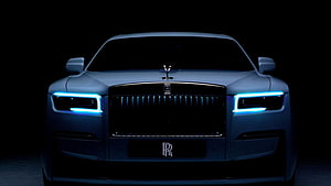 Front View of Rolls-Royce Ghost with Glowing Blue LED Headlights in Dark Atmosphere HD wallpaper