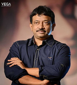 Ram Gopal Varma Professional Portrait in Navy Blue Shirt with Arms Crossed HD phone wallpaper
