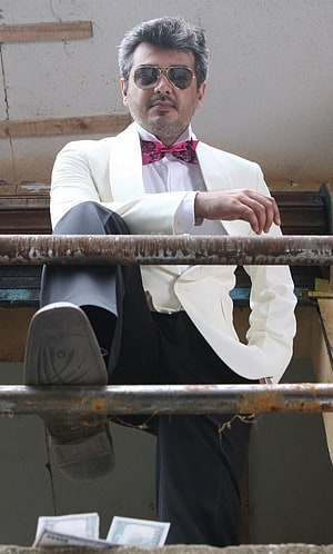 Ajith Kumar in white tuxedo with pink bow tie and aviator sunglasses HD phone wallpaper