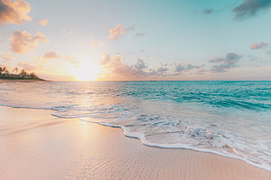 Golden Sunset Over Turquoise Ocean Waves Lapping on White Sand Beach HD wallpaper