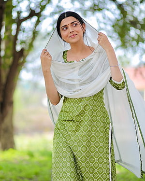 Nimrat Khaira in Green Patterned Salwar Kameez with White Dupatta in a Garden HD phone wallpaper