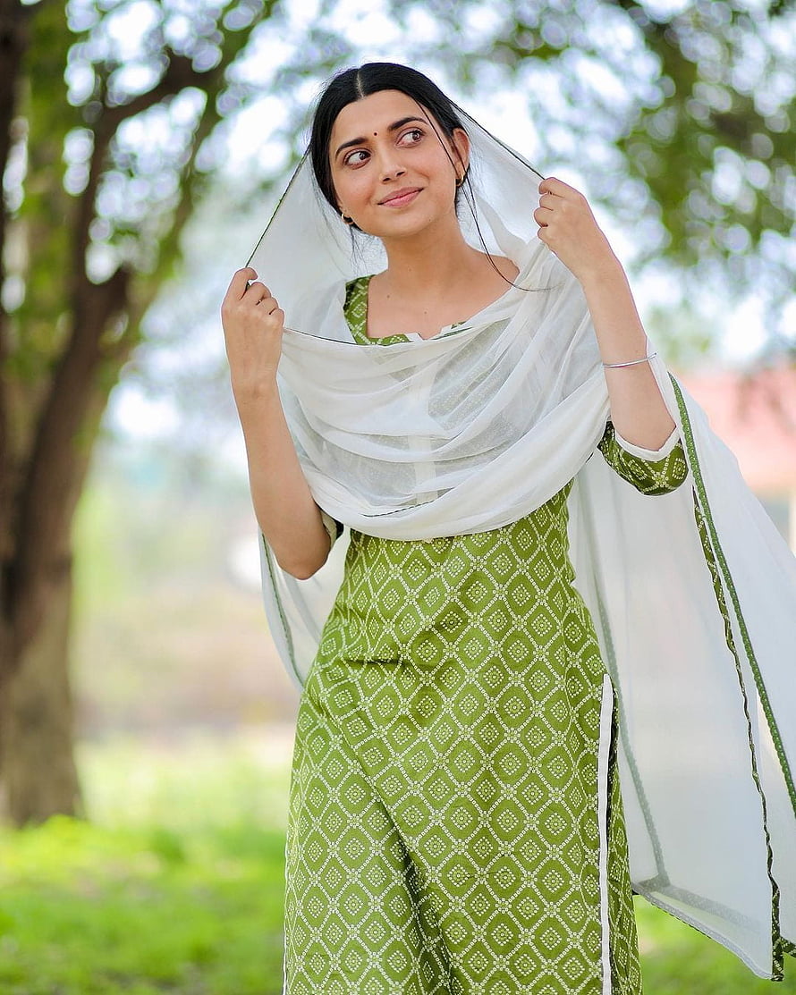 Nimrat Khaira in Green Patterned Salwar Kameez with White Dupatta in a Garden HD phone wallpaper