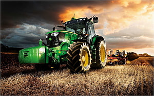 John Deere Tractor Plowing a Golden Field Under a Dramatic Sunset Sky HD wallpaper
