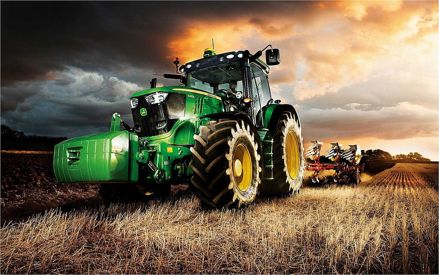 John Deere Tractor Plowing a Golden Field Under a Dramatic Sunset Sky HD wallpaper