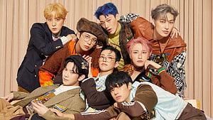 ATEEZ Group Portrait in Stylish Streetwear Against Beige Curtain Backdrop HD wallpaper