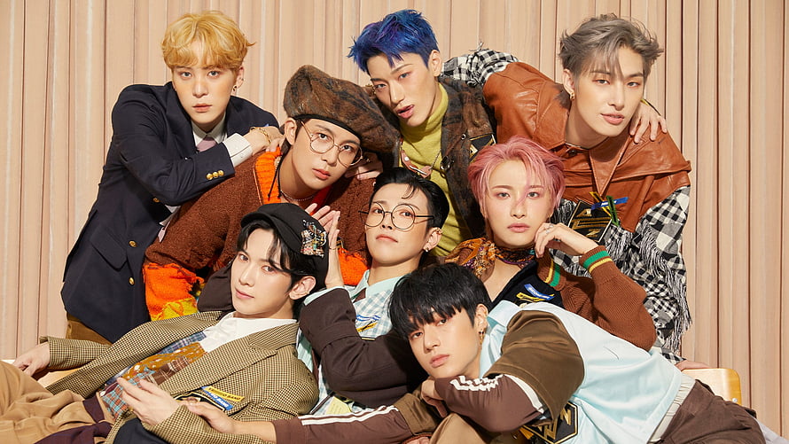 ATEEZ Group Portrait in Stylish Streetwear Against Beige Curtain Backdrop HD wallpaper