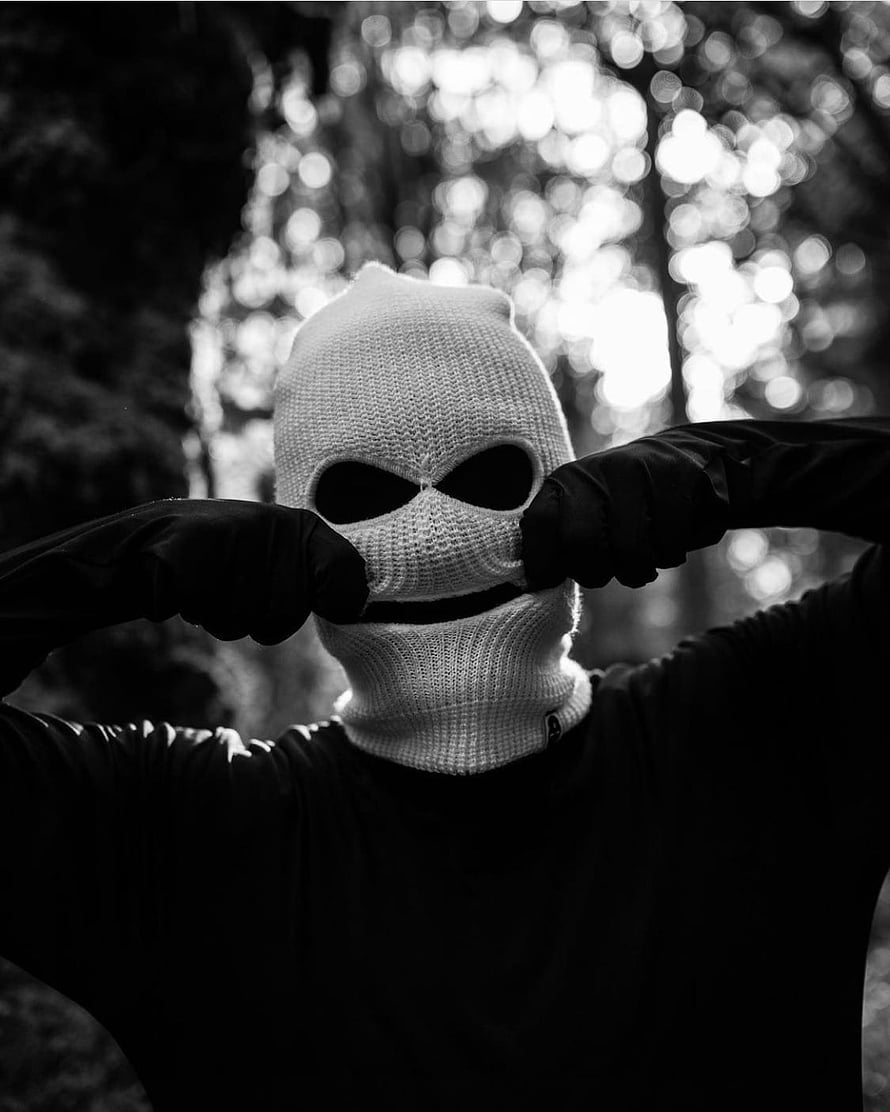 Black and White Portrait of a Person Wearing a Knitted Ski Mask and Gloves in a Forest HD phone wallpaper