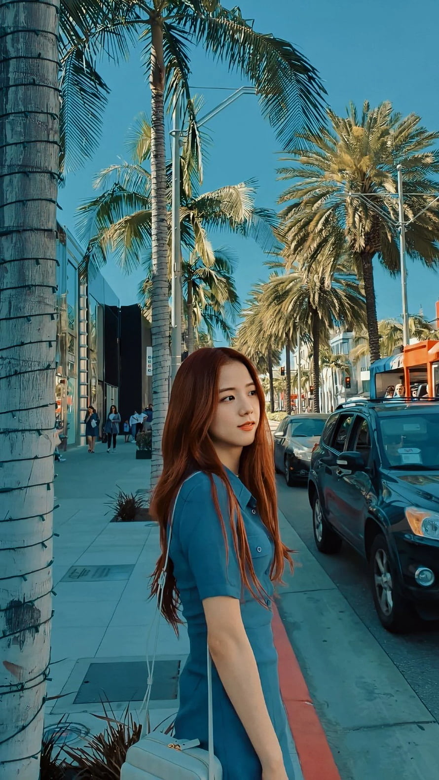 Jisoo from Blackpink in a blue dress on a palm-lined street in Los Angeles HD phone wallpaper