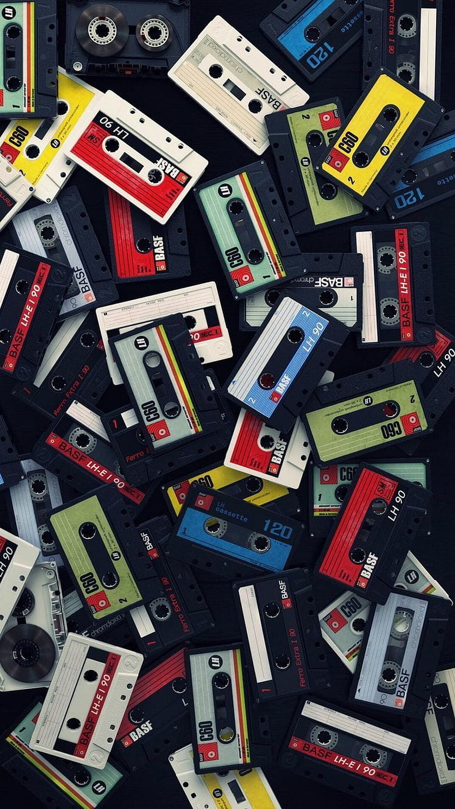 Vintage Audio Cassette Tapes Scattered on Dark Background HD phone wallpaper