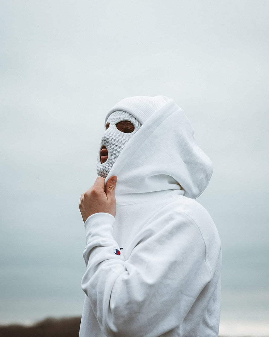 Person in white hoodie and balaclava mask against overcast sky HD phone wallpaper