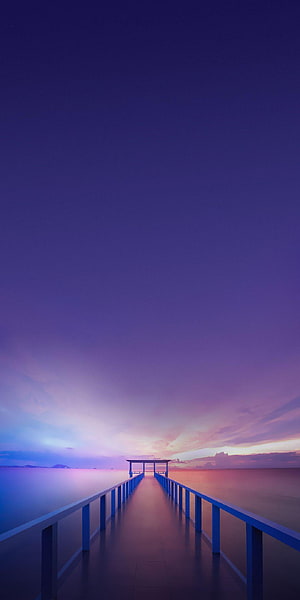 Serene Blue Pier Extending Into Calm Ocean Under Purple Sunset Sky HD phone wallpaper